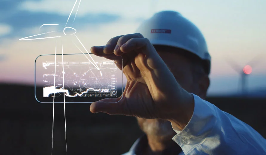 Techniker hält Handy mit Plan einer Windkraftanlage hoch