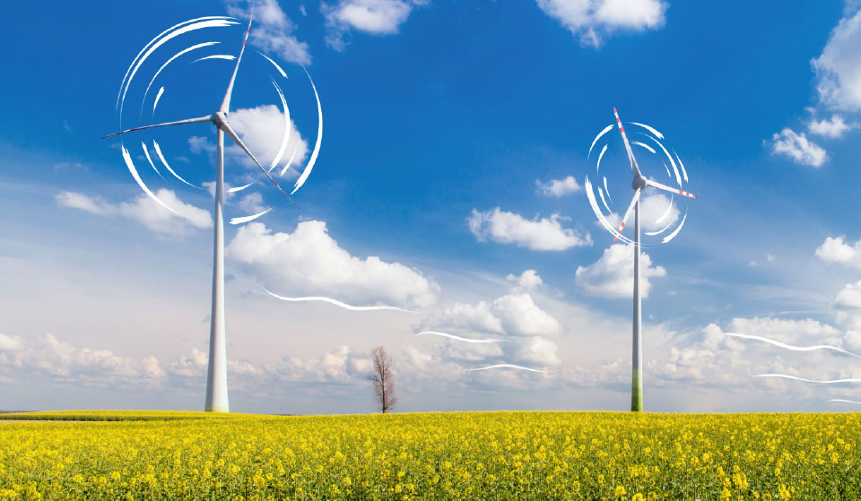 Windkraftanlagen stehen im Blumenfeld, Wind weht